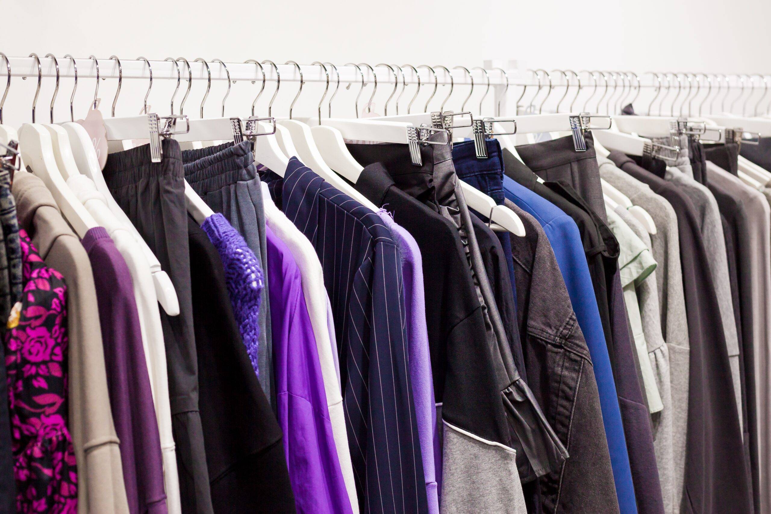 A rack of clothes, most of them black or another dark color.