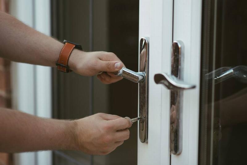A person unlocking their door with a key.